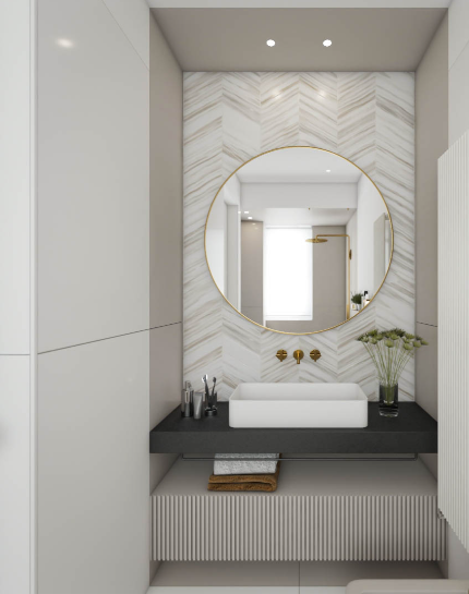 Contemporary bathroom in Westchester, NY with a marble herringbone backsplash, floating white sink, and a round mirror framed in gold, reflecting a minimalist design aesthetic.
