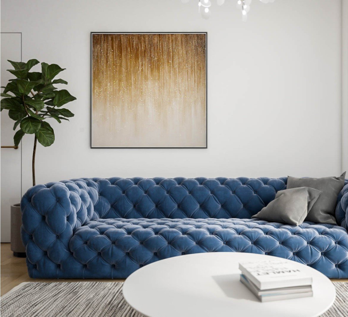 Home renovation showcasing a luxurious blue tufted sofa, an elegant gold and white wall art, alongside a lush green potted plant in a modern living room setting.