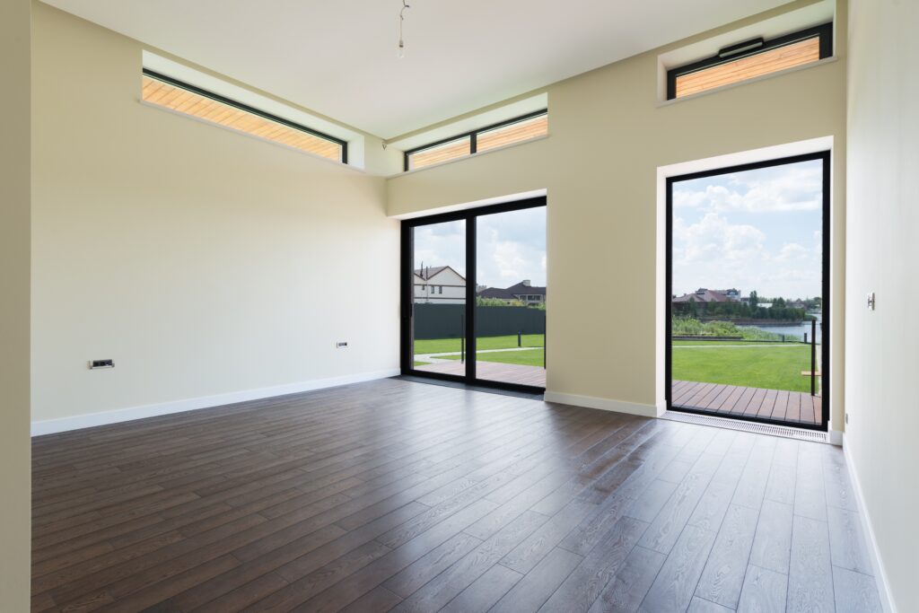 Spacious room with elegant wood flooring installed by a professional flooring contractor.