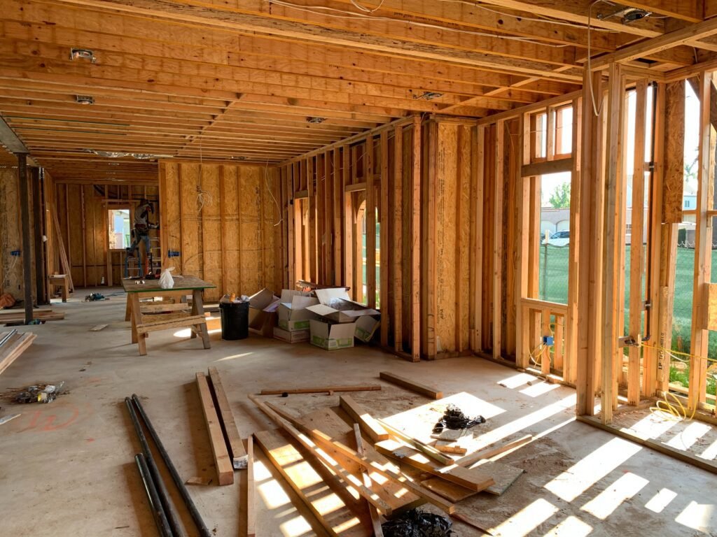House renovation contractor working on interior framing of a residential structure.